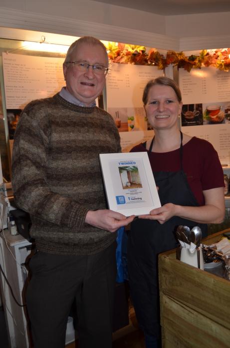 FLUSHED WITH SUCCESS: Café owner Carly Payne received the toilet-twinning certificate from local co-ordinator Ian Blake