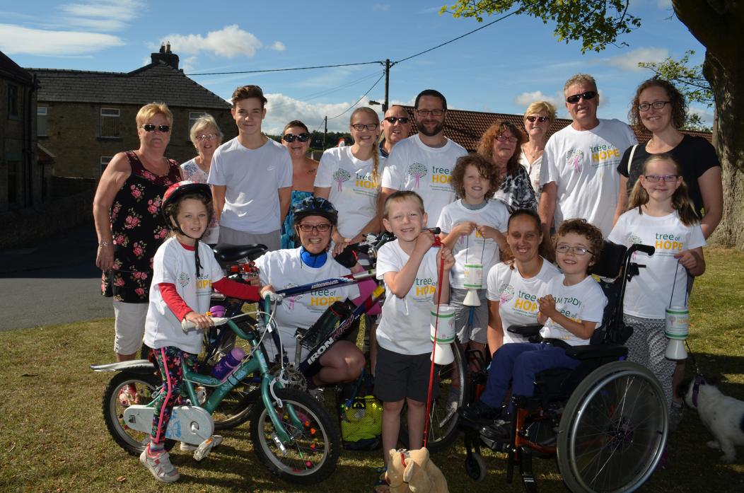 PEDAL POWER: Sophie Hebdon, left, and mum Katy, are cheered off by Jack Hopper, William Hebdon, Nicola Short, Teddy Berriman and supporters as they start their fundraising bike ride