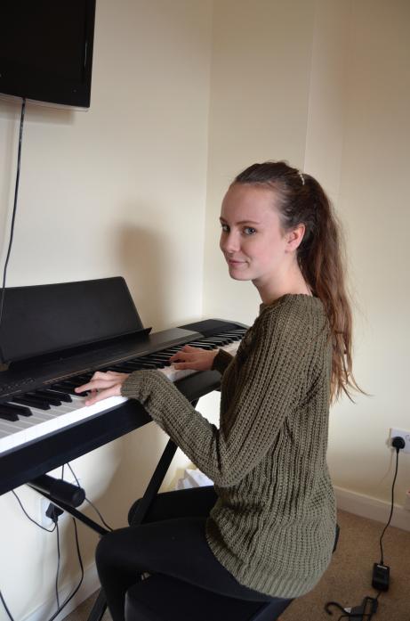 TUNING UP: Jeshika Bassett practising on her new keyboard at home