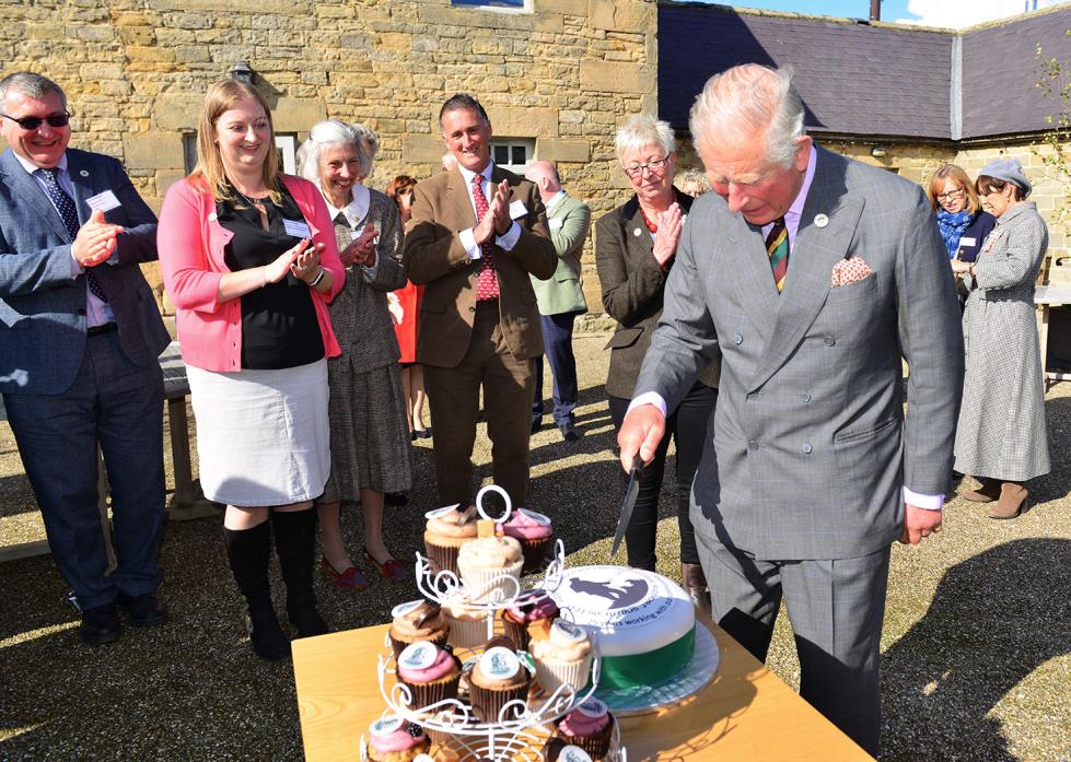Ian Tallentire, Emma Spry, Revd Rachel Benson, Richard Matthews and Diane Spark look on as Prince Charles cuts a cake to mark the 25 anniversary of Utass (Upper Teesdale Agricultural Support Services)