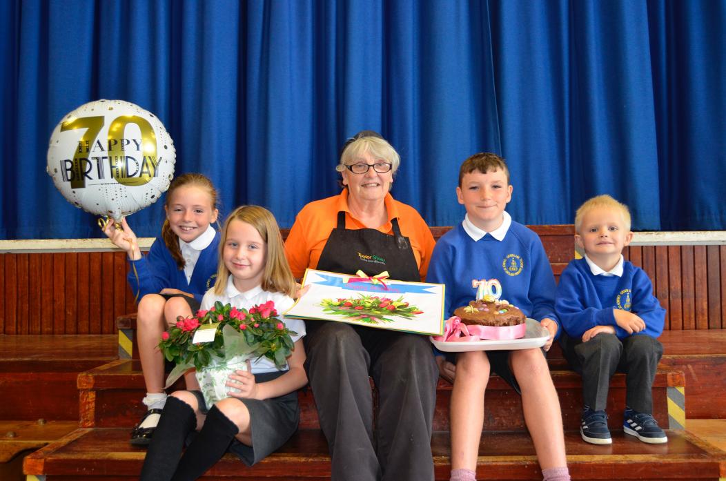 SWEET TREAT: Lilian Carlington with Oli Linsley, who baked her a cake and students Rosie Dart Josie Murray and Oli Spence