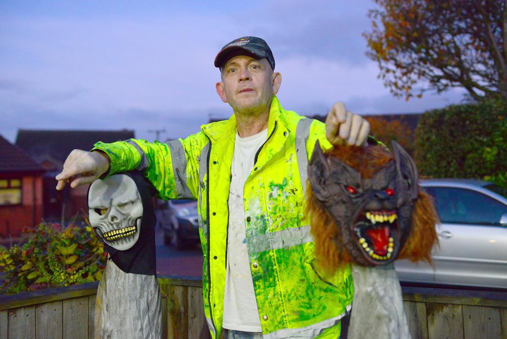 SCARY NEIGHBOUR: Etherley’ Gary Shaw with the friendly meerkat carvings that he has transformed into Halloween ghouls. He plans to go even better this Christmas