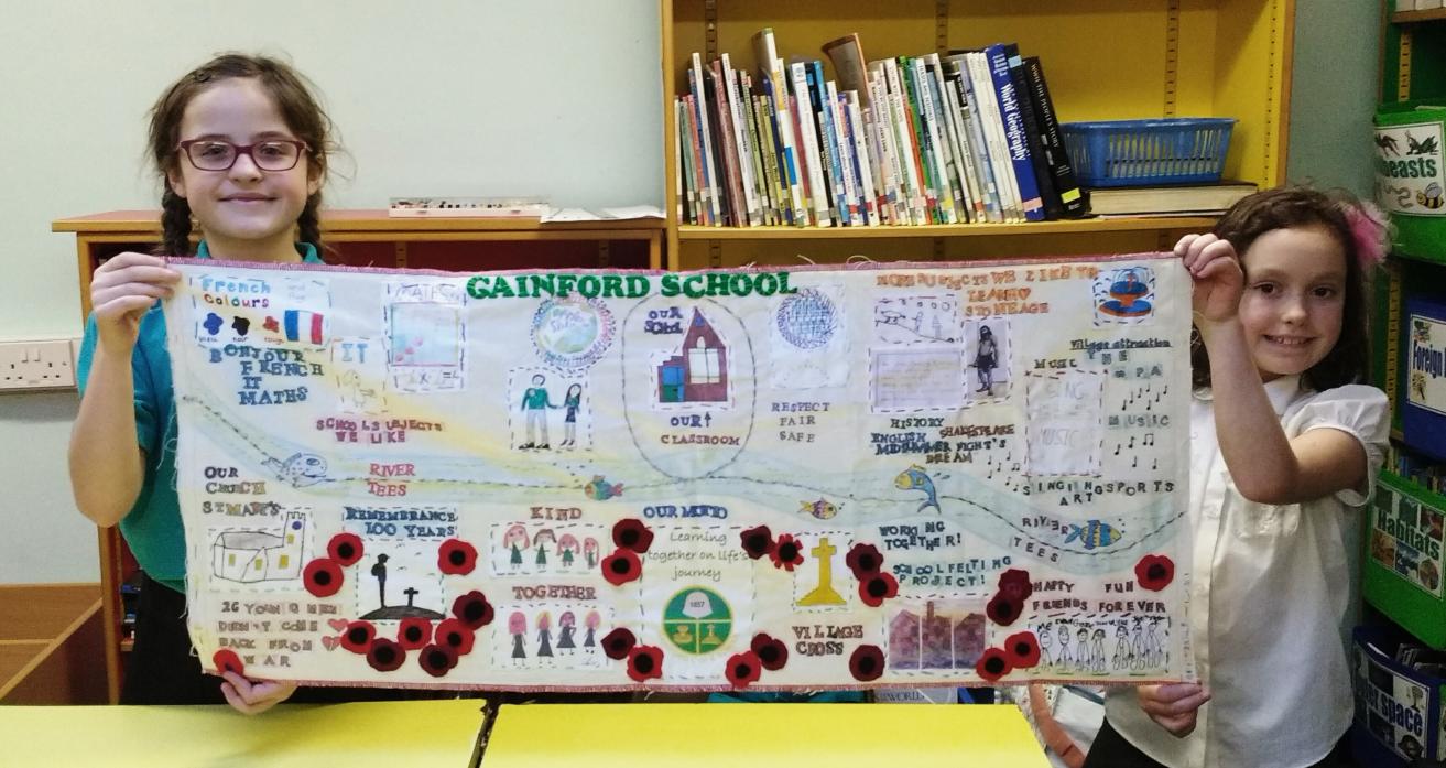 CLASS ACT:  Katie and Chloe from Gainford Primary School with embroidery created by pupils as part of a world record attempt