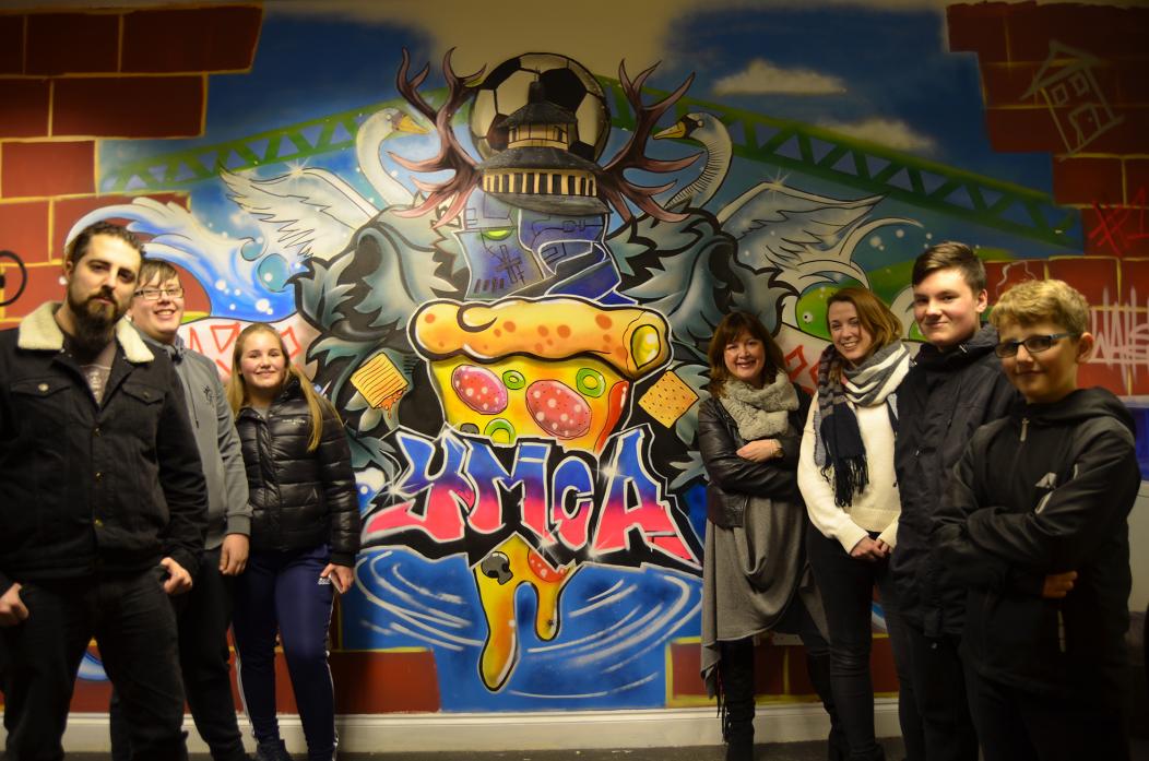 AMAZING ART: The colourful mural on show at Teesdale YMCA centre. From the left, artist Dan Walls, Matthew Allen, Maisie Beckley, Julia Dunn from the Bowes Museum, YMCA’s Rachel Dyne, Connah Ellison and Corey Playle