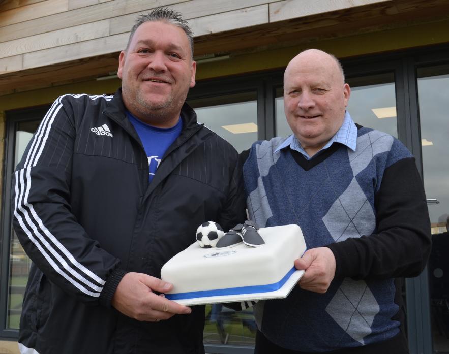 BACK OF THE NET: Mark Carter presents Pat Estall with a specially decorated cake to mark his 35 years with junior football in Barnard Castle