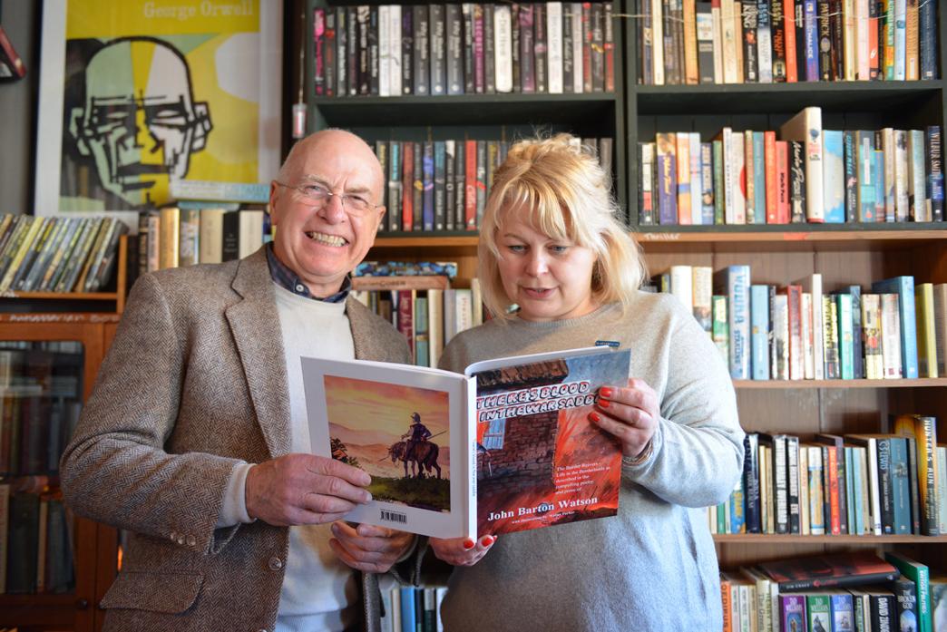 BLOODY STORY: Author John Watson and Curlews book shop owner Emma Rowell browse through a pre-print edition of There’s Blood In The War Saddle, which will be launched on March 21