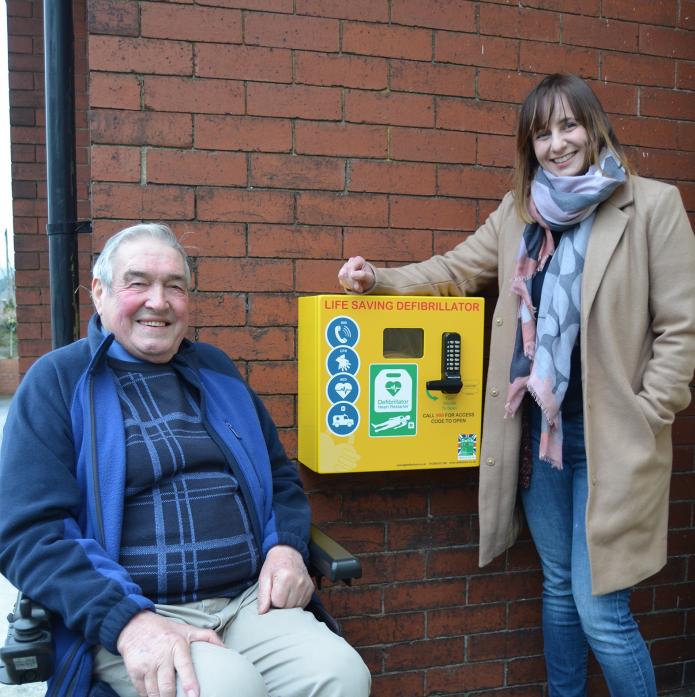 Cllr Colin Mairs and Cllr Rachel Garnett-Gillens with one of the defibrillators at the Monteith Memorial Community Centre