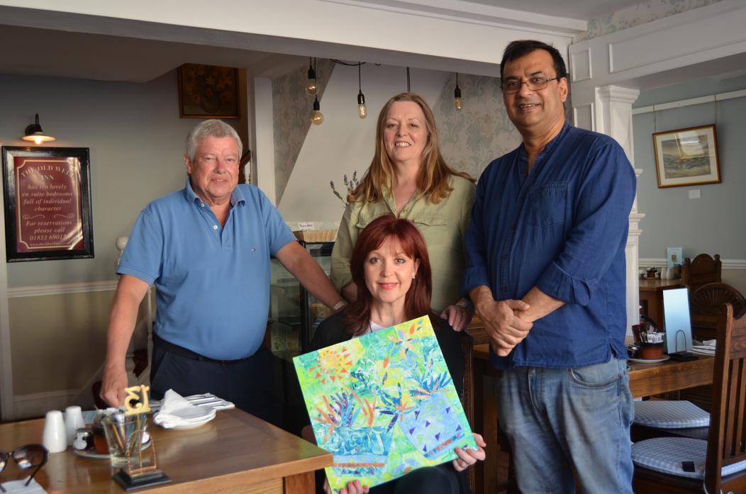 UPLIFTING: Artist Jane Young with landlord Roy Chatterjee, left, and art class members who will be displaying their work, Ann Gill and Bill Laver