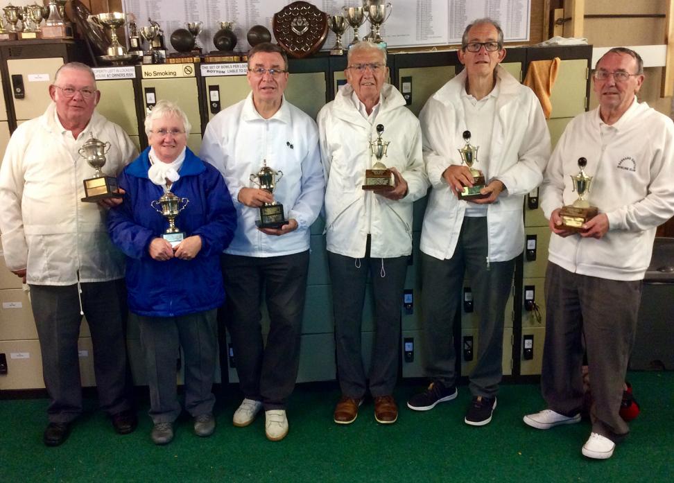 UNDER COVER: In the shelter of the club house are, from left, Club Triples winners Alwyn Dowson, Mary Lambert and Kevin Cross, with runners-up Tony Barkshire, Peter Rimmington and Peter Shovlin
