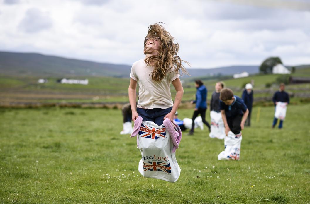 JUMPING FOR JOY: Hannah Scott coming in first place in the sack race
