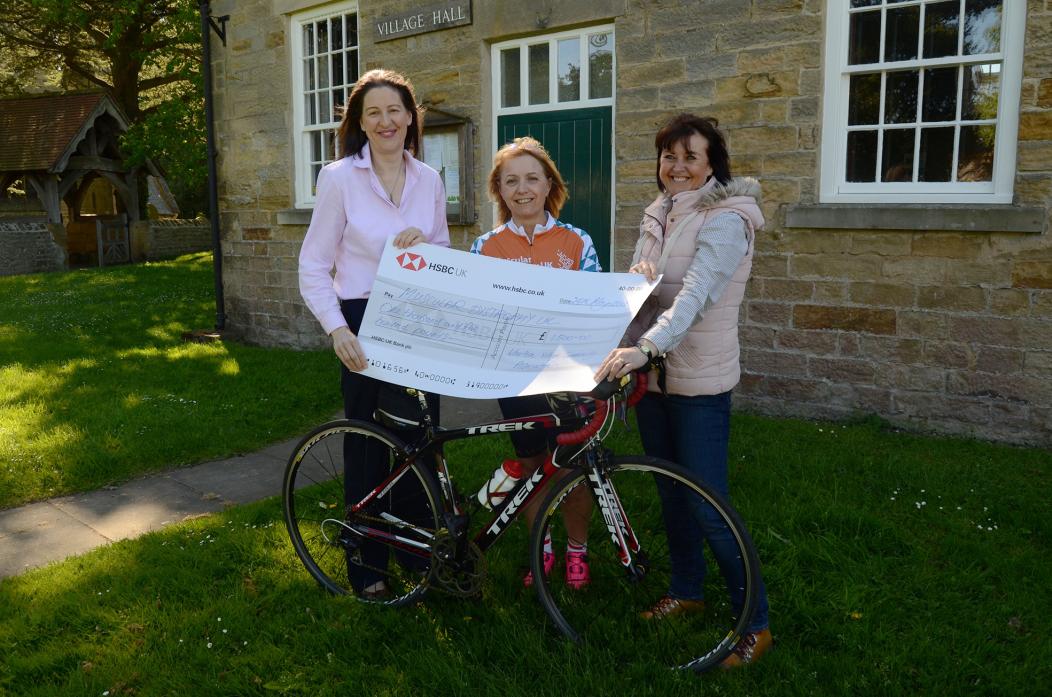 ON YOUR BIKE: Members of Whorlton Village Hall committee Jane Robineau, left, and Dianne Darville, right, with keen cyclist Lynne Cummins. They helped to raise £1,500 to fund research into muscle wasting disease