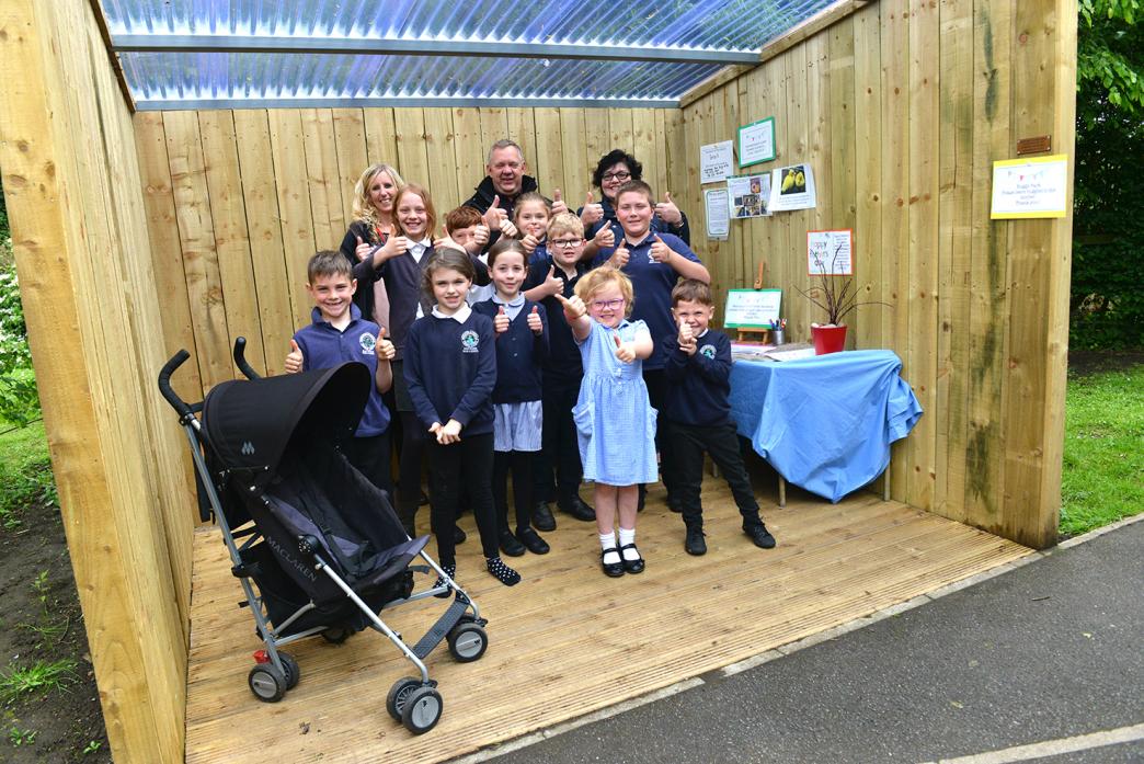 SCHOOL PROJECT: Andy Mitchell, Faye Docherty, Christine Mitchell and pupils give the new rain shelters at Middleton-in-Teesdale Primary School the thumbs up. Left, Peter Henderson, of Middleton Forge, with and Jack Wallace admire the plaque put up in one