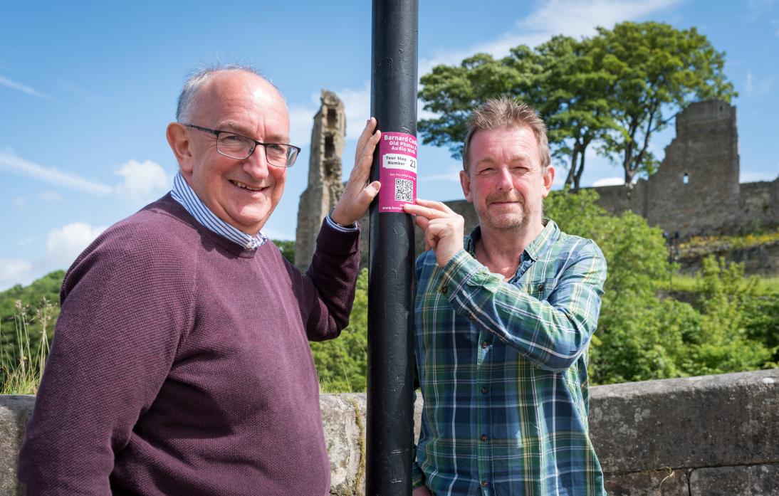 HISTORY BOYS: Brothers Geoff and Peter Dixon put up stickers that provide QR codes for a phone app