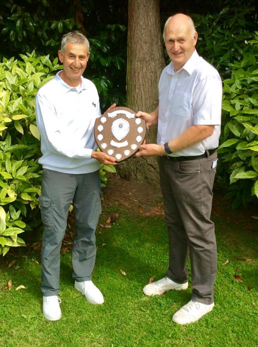 WORTHY WINNER: Brian Smurthwaite receives the Robert Littlefair Trophy from Michael Littlefair