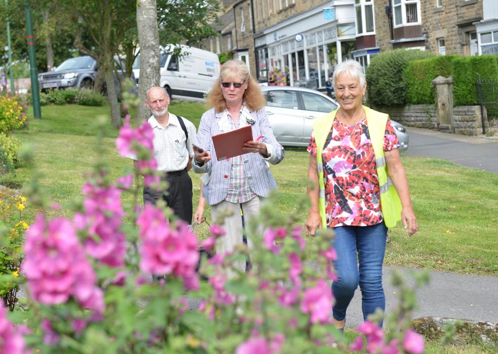 PRETTY IN PINK: Middleton-in-Bloom organiser Pam Phillips leads environmental competition judges Sue Townsend and Jane Hastings along the border planted and maintained by the village’s Women’s Institute