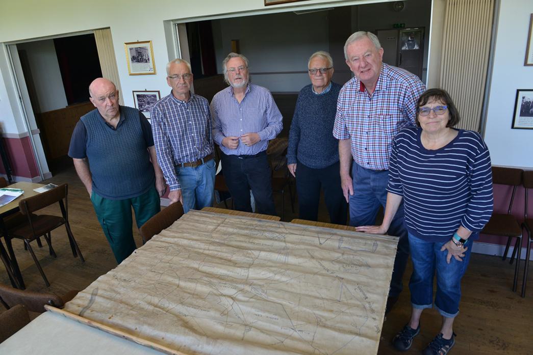 ALL MAPPED OUT: Upper Gaunless Valley History Trust members Ian Mills, Nigel Bryson, David Wallace, Raymond Kellet, Fred Aitken and Jeanette Newell pour over the recently discovered Lynsack and Softley parish map dating back to 1757