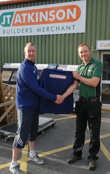 CLUB SUPPORTERS: Dave Kidd, of JT Atkinson presents Andrew Hall with the new training tops