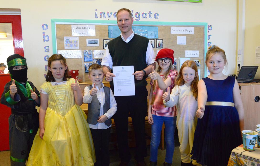 SUCCESS WITH SUMS: Headteacher Chris Minikin celebrates with children from Montalbo Primary School after the school emerged in the top one per cent in England for achievement in mathematics