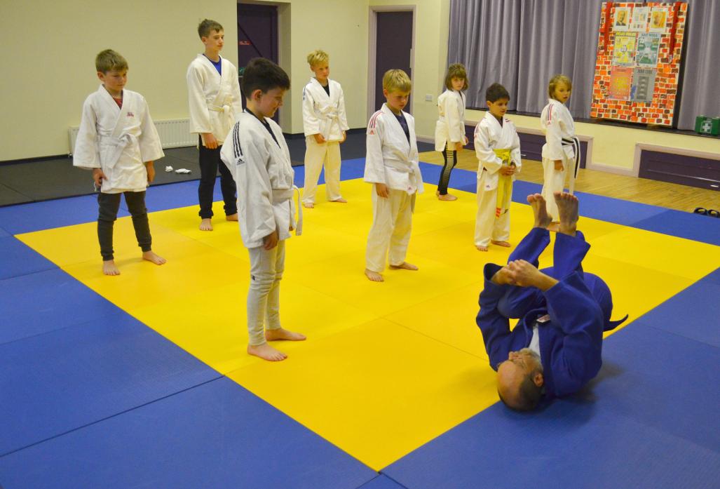 NEW CLASS: Judo instructor Adrian Harding demonstrates a move to junior members of his new class at Ingleton Village Hall