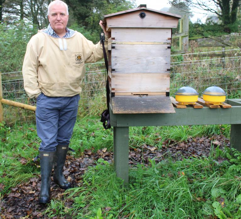 HIVE OF ACTIVITY: Tim Pearson with one of his bee hives