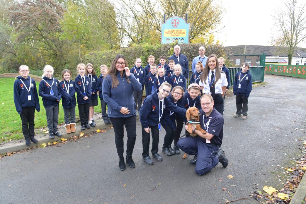 TAKING ACTION: Amanda Fulcher of Believe Housing, fire investigator Lee Aspry, fire search dog Archie and Cheryl Stirk, from County Durham and Darlington Fire and Rescue Service, with the Phoenix Fire Champions from Oakley Cross School