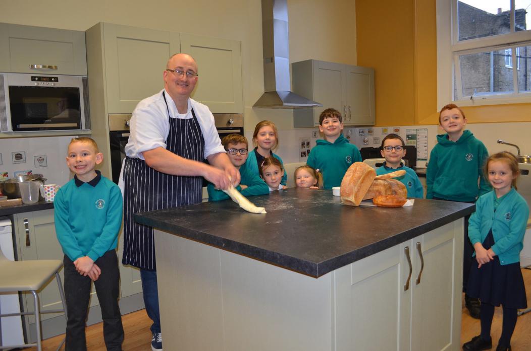TRADITIONAL LESSONS: Baker Owen Moody, from Coghlans, gave pupils at Bowes Hutchinson’s Primary School a masterclass in baking bread 												    TM pic