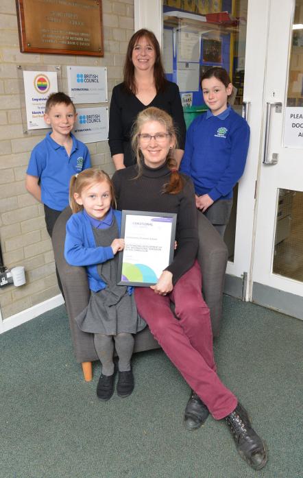 AWARD WINNERS: Pupils Alfie, Emily and Ava with headteacher Lynn Cowens and French teacher June Stephens  	            TM pic