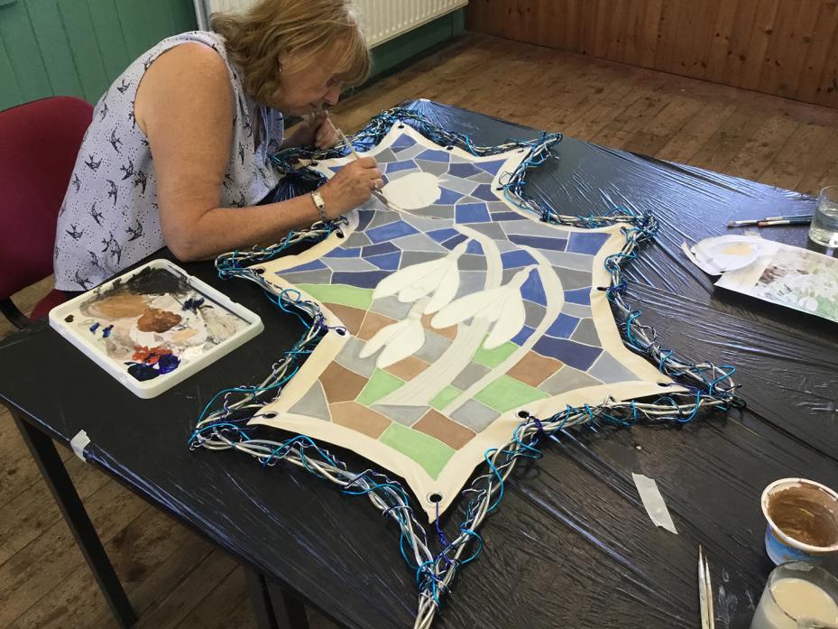 COMMUNITY ART: Work on one of the four panels depicting the seasons at Hamsterley Village Hall