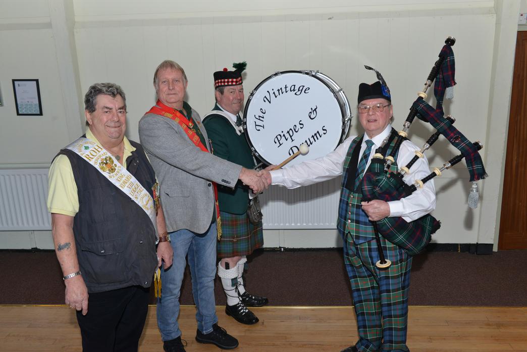 GIFT: Secretary of the King Edward VIII Lodge of the Royal Antediluvian Order of Buffaloes Roy Fletton with pipe major Barry Waldron, and drummers Malcolm and Derek Bonnett during the handing over ceremony of a new bass drum to Vintage Pipes and Drums ban
