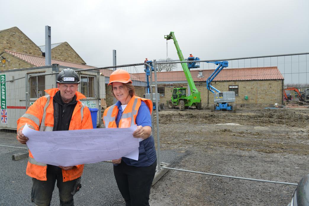 BIG PLANS: Mainsgill Farm Shop owner Maria Henshaw reviews plans with contractor Richard Keys while workers from S&A put up the metal framework of a new extension  									TM pic