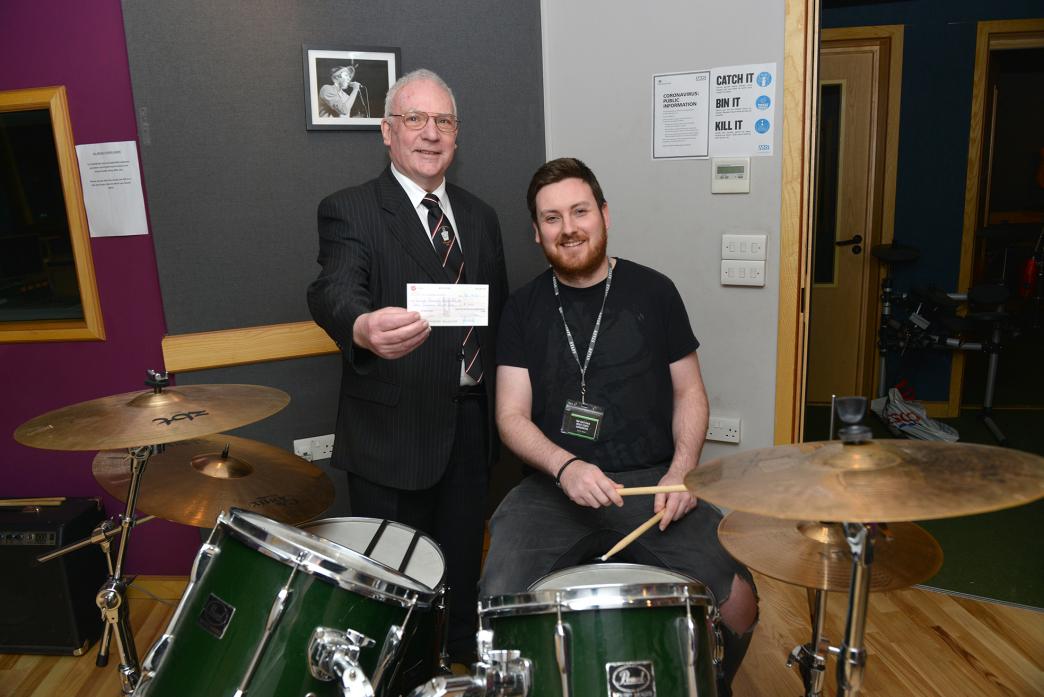 ON SONG: Mike Jacques, of the Marks Master Masons of Durham, hands over £1,000 to The Hub’s music studio co-ordinator Tom Whittaker