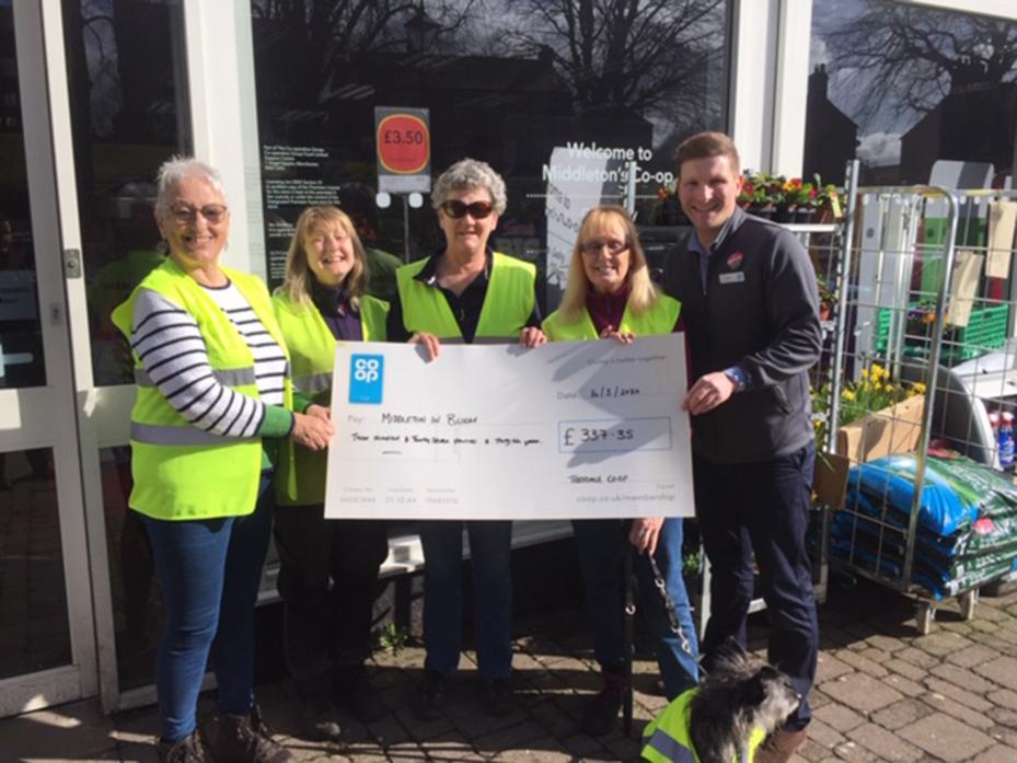 FLOWER POWER: Middleton-in-Teesdale Co-op manager Tom Ridley presents cash to the village’s in-bloom organisers Pam Phillips, Christine Cartwright, Lindsey Peppal and Jo Lee