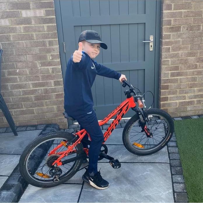 THUMBS UP: Alfie Metcalfe, whose bike ride raised £1,385 for a scheme supporting vulnerable and key workers – and whose efforts received praise from Manchester United's Harry Maguire
