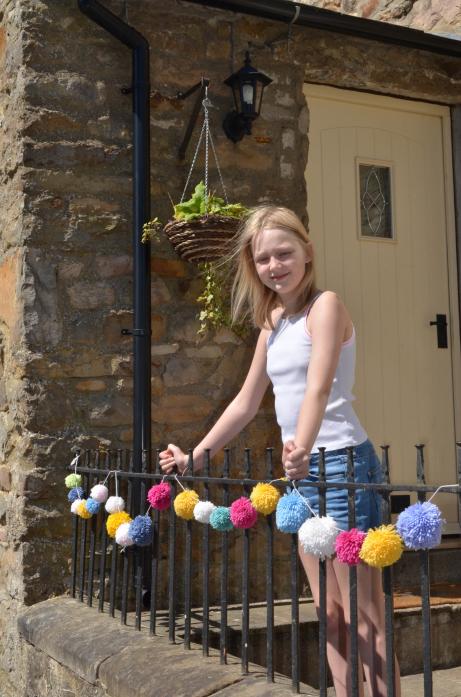 COLOURFUL EFFORT: Crafty Grace Harrison raised funds for a dale charity creating pom-pom garlands