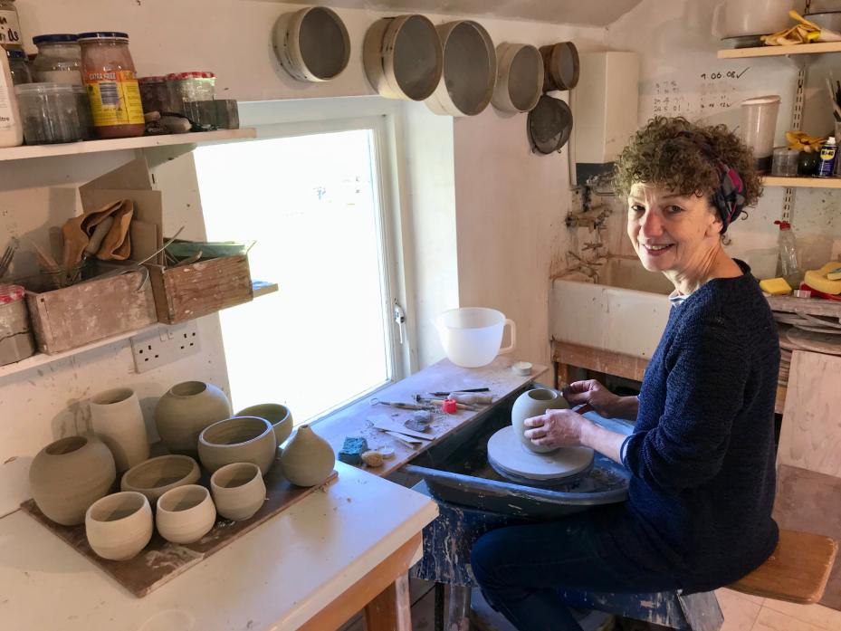 FAMILY: Judy Caplin at work in her studio creating #throwforthenhs pottery items