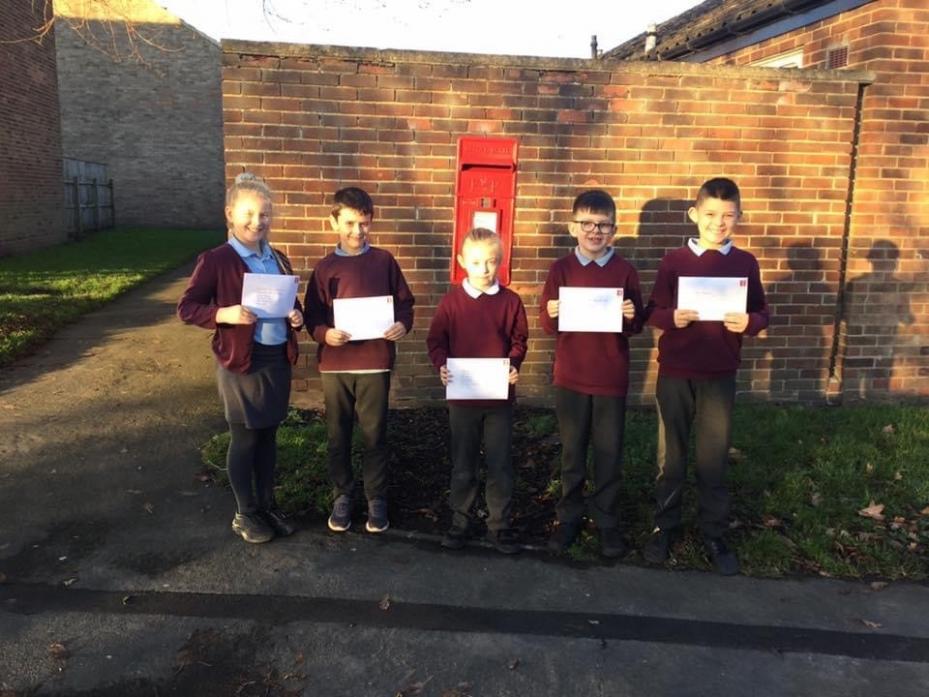 PROUD: Oakley Cross pupils posting letters to Boris Johnson, local MPs and the parish council on the subject of children’s rights