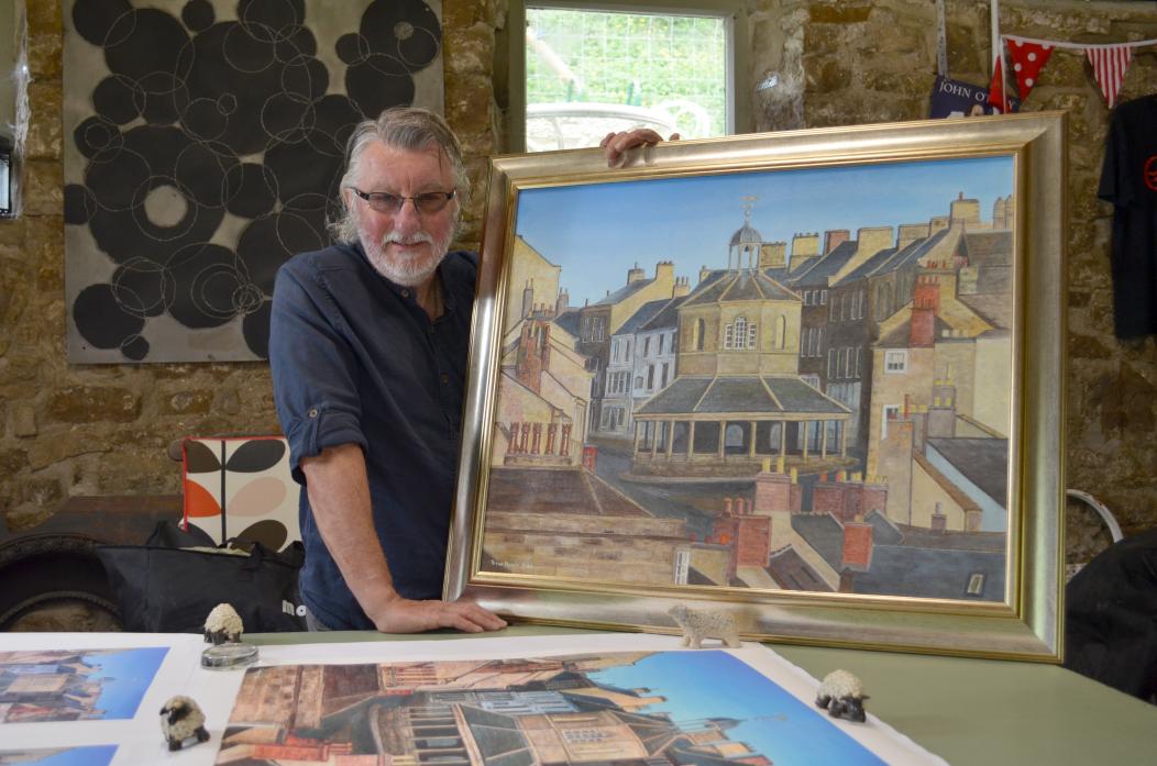 FAMILIAR VIEW: Dave Palmer in his home studio in Startforth with his latest work, the Market Cross, in Barnard Castle, that will used on postcards along with other pieces of his work