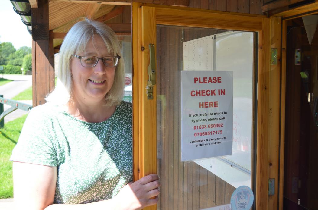 CAUTIOUS AND CAREFUL: Alison Lamb at the reconfigured reception office at Doe Park. Right, Adam Morris ensures the grounds are ready to welcome guests to the caravan park