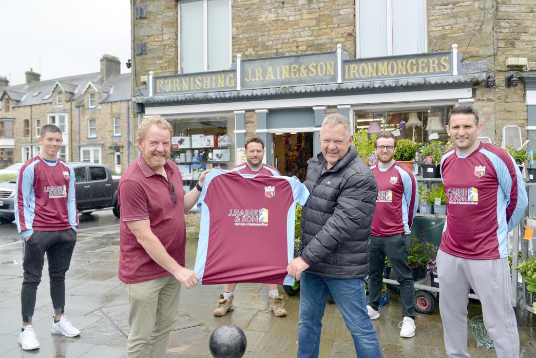 NEW STRIP: Footballers Kane Mitchell, Dave Short Liam Bell and Ty Morgan look on as Nigel and Andy Mitchell, of J Raine and Son, hold up Middleton Wanderers’ new colours