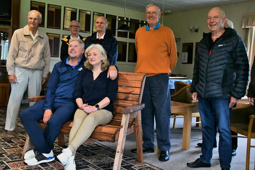 FOND FAREWELL: Darren Pearce and Shirley Bradshaw on the bench awarded to them by the golf club's senior section to mark Darren's departure after 26 years as the club's professional. Standing, from left, are senior members Sid Lowes, Peter Holliday, Mick