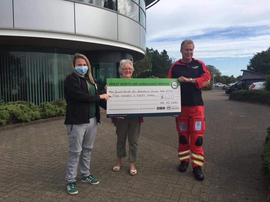 CASH HELP: Great North Air Ambulance Service staff member Sophie Bendelow and chief pilot Jay Stewart gratefully receive £420 from Gainford pensioner Margarite Dunn