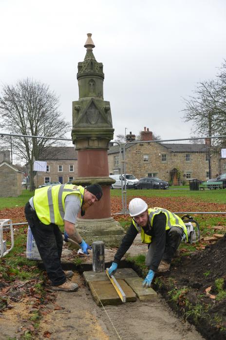 FRESH LOOK: Brian Ellison and Thomas Pavlou, from Stone Technical Services, use reclaimed York stone to create paving up to Staindrop’s historic drinking fountain