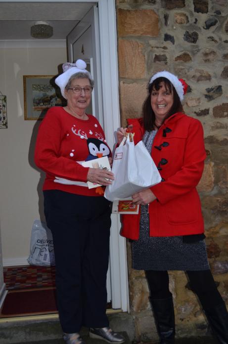ALL SMILES: Teesdale Day Club member Phyllis Wood was delighted to receive a surprise Christmas hamper from club leader Kim Weston  		             TM pic