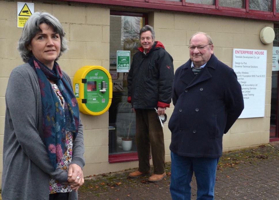 DEFIB DELIGHT: Emma King, from Enterprise House, with county councillors Ted Henderson and Richard Bell    								             TM pic