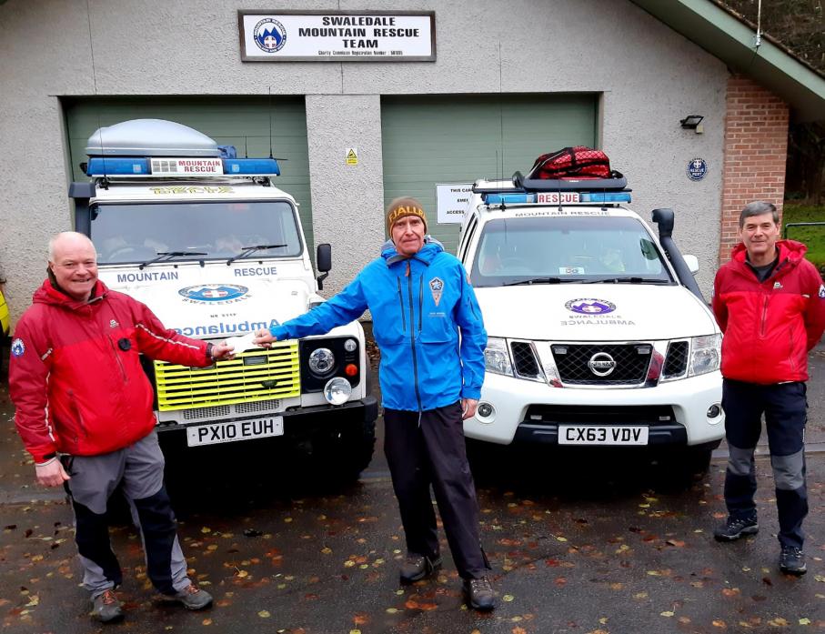 APPEAL BOOST: Alan Hinkes hands over a cheque for £435 to Steve Clough, rescue controller for Swaledale Mountain Rescue Team, watched by Graham Brown, assistant equipment officer
