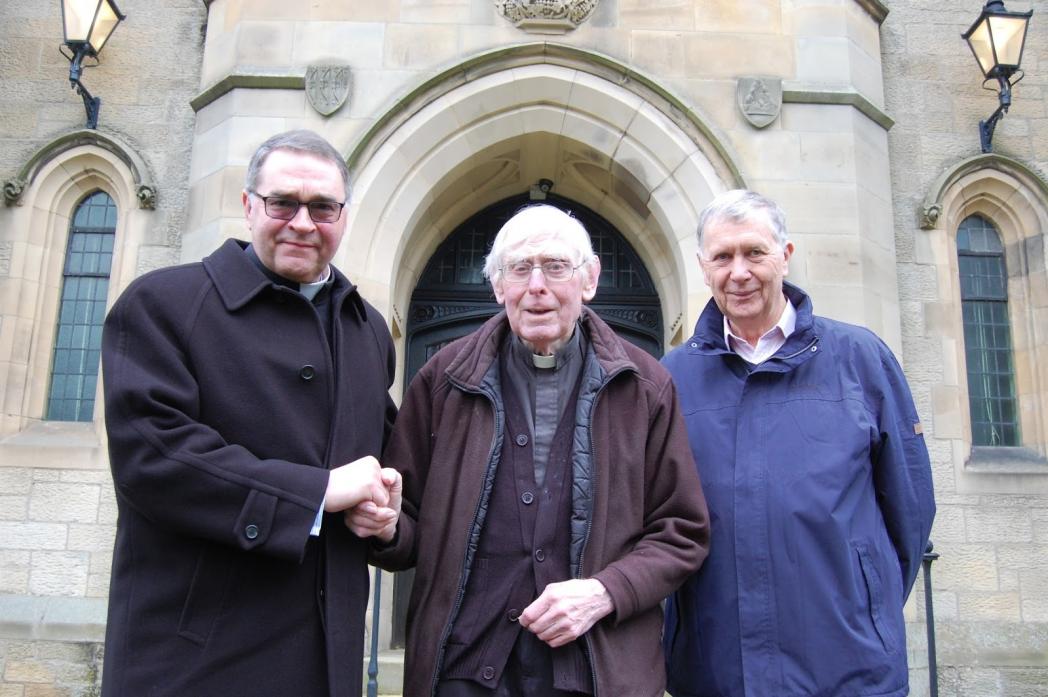 REMEMBERED: Father Elkin, centre, on his retirement four years ago