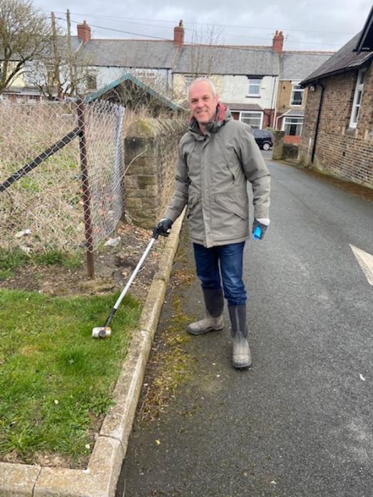 HAPPY TO HELP: Gordon Nicholson retrieves litter from the kerbside