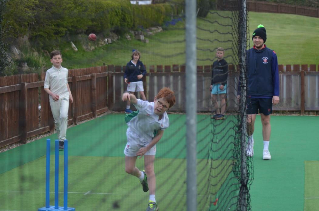 YOUNG STARS: Coach and first team bowler Josh Bousfield casts an eye over some of the juniors at Barnard Castle CC