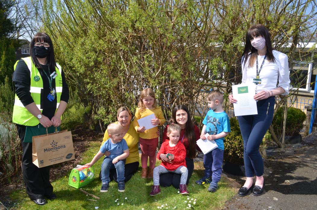 GARDEN PROJECT: Gillian Robinson and Emma Hepper, from Morrisons, present Jemma Fletcher and Ruth Tarn, from Green Lane School Nursery, with the gardening pack. Pictured are youngsters Evie, Asher, Oliver and Remus