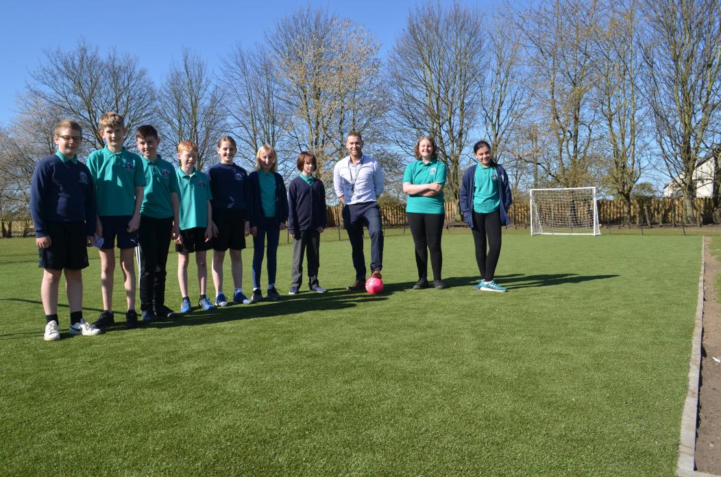 BOOST FOR VILLAGE: Steve Whelerton with pupils at Staindrop Primary School on the new all-weather pitch